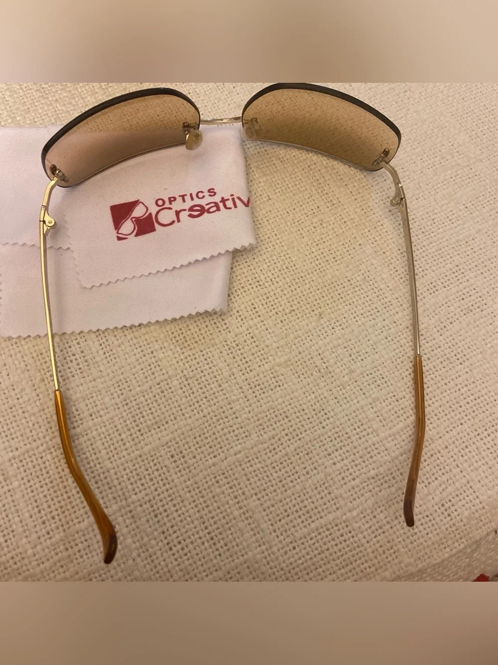 2000s style creative optics sunglasses with brown lenses and gold frames